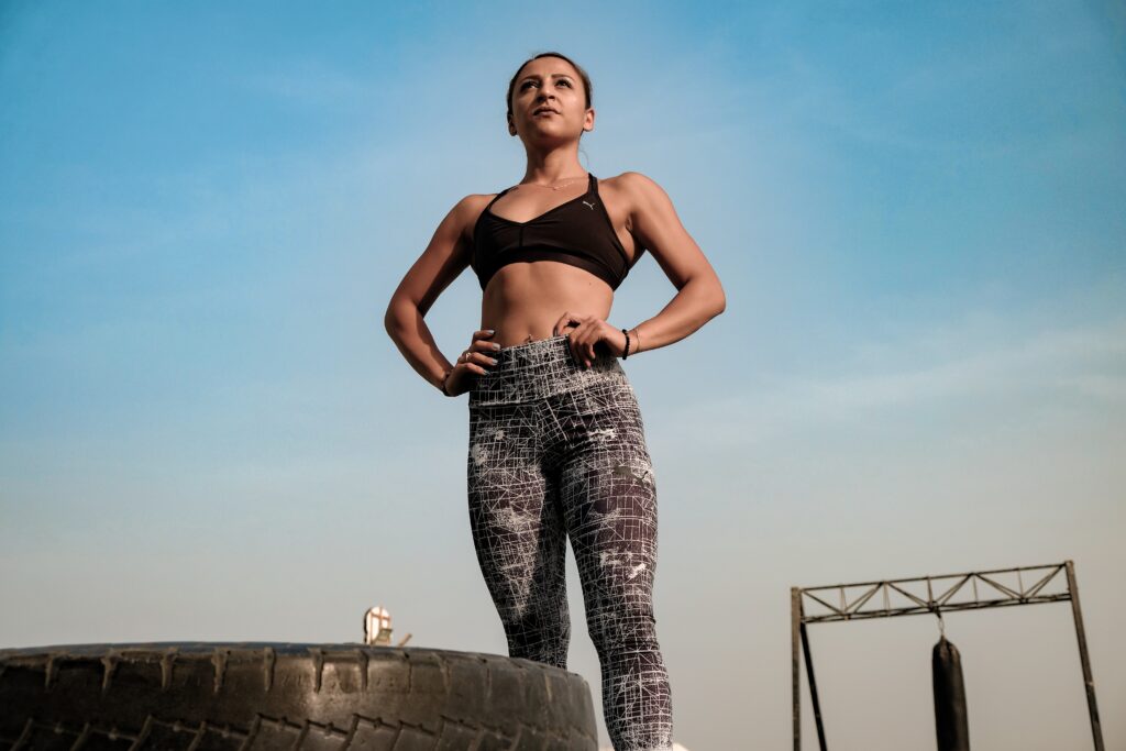Strong woman posing after HIIT workout