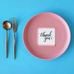 table setting meal preparation with thank you card on round plate t20 jRBP7X