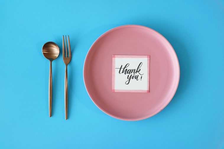table setting meal preparation with thank you card on round plate t20 jRBP7X