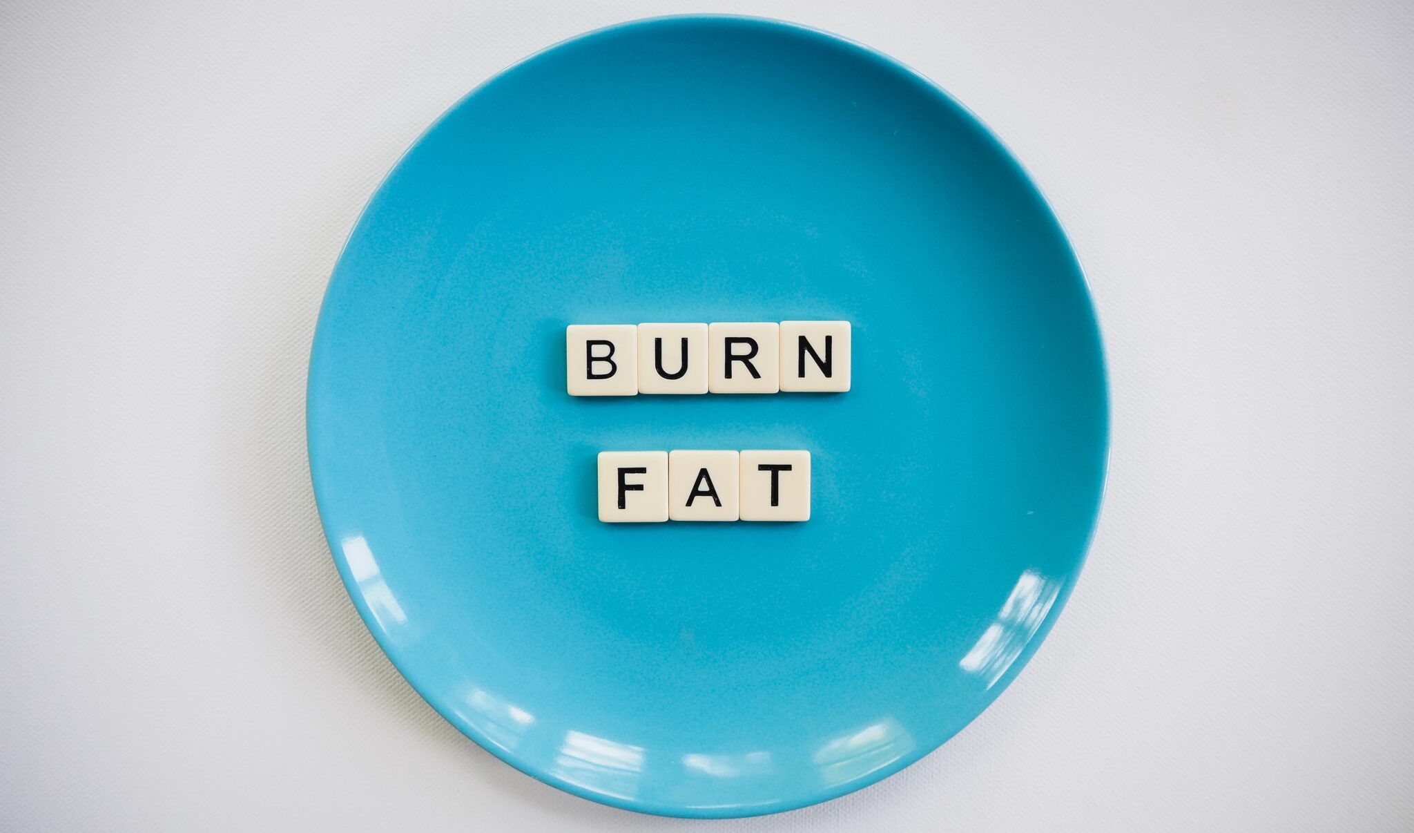 photo of a burn fat text on round blue plate 2383009