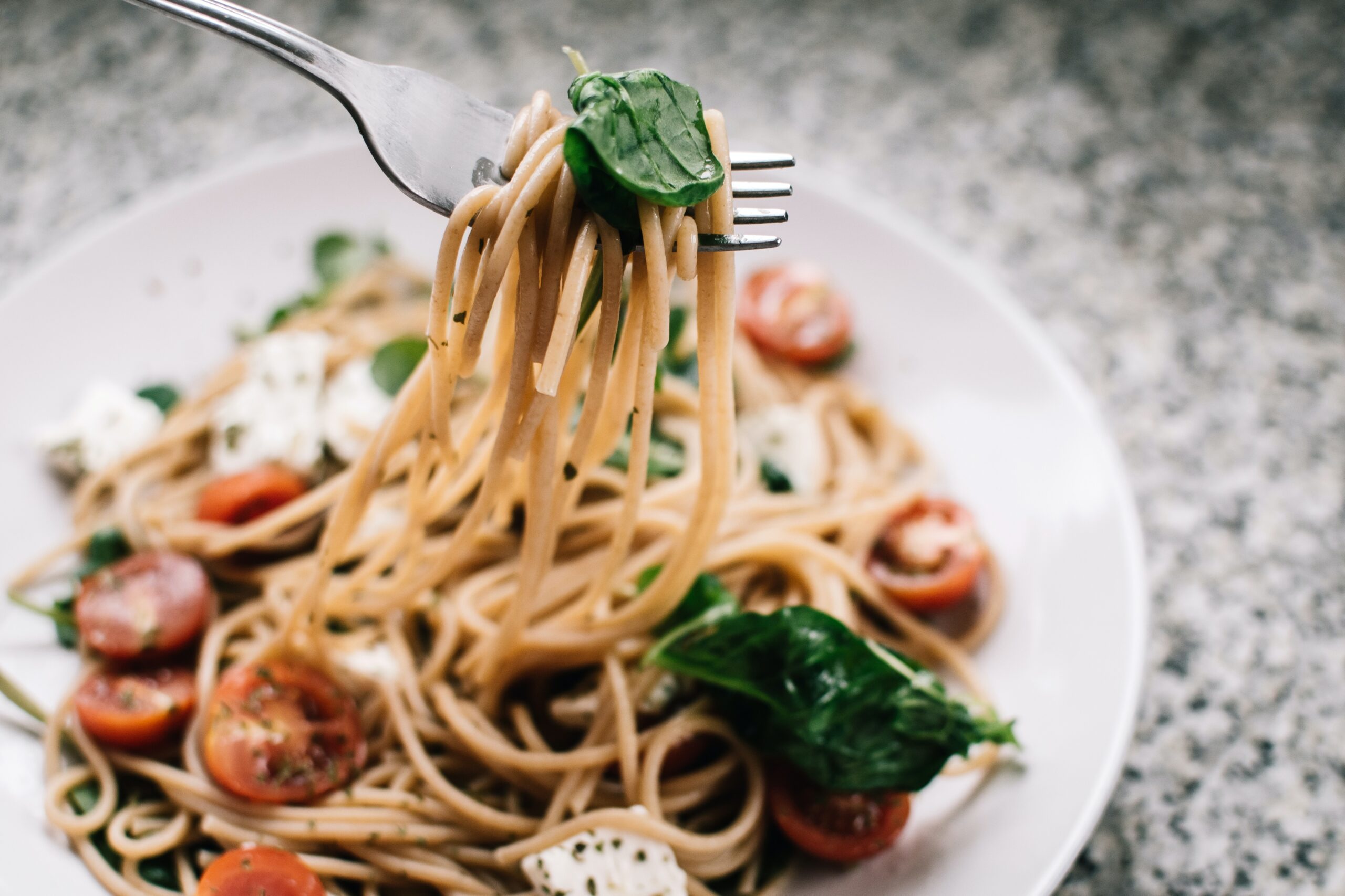selective focus photography of pasta with tomato and basil 1279330